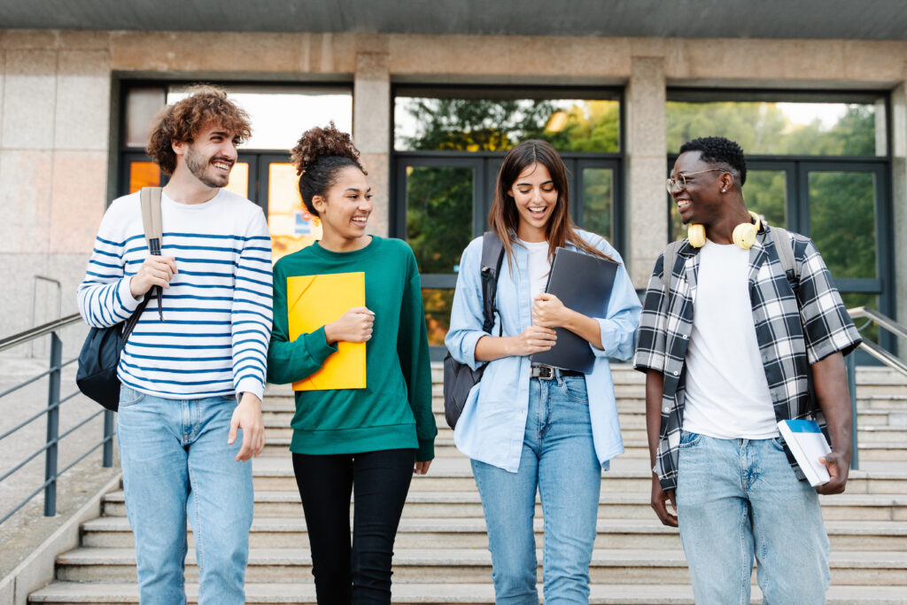 Four students walking together on campus