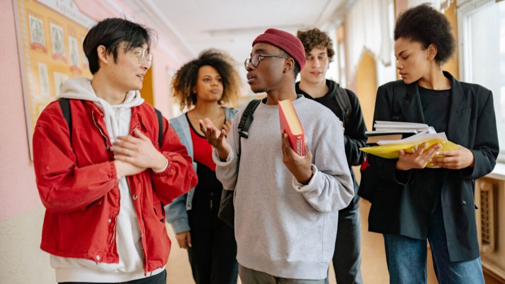 students discussing in hallway